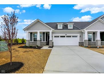 Charming home showcasing a two-car garage, grey shingle siding, stone accents, and professional landscaping at 260 Onset Way, Westfield, IN 46074