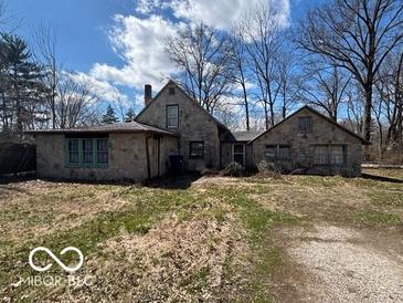 Stone and brick home with a charming vintage aesthetic and a spacious front yard at 326 N Grant St, Brownsburg, IN 46112