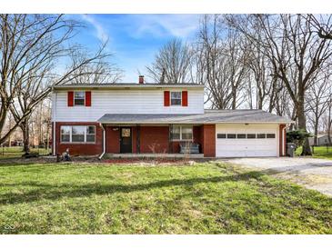 Inviting two-story home featuring a brick facade, white siding, and a two-car garage at 333 E Waterbury Rd, Indianapolis, IN 46227