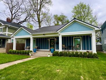 Charming blue home with front porch, well-maintained lawn, and inviting curb appeal at 3535 Birchwood Ave, Indianapolis, IN 46205