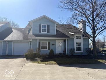 Charming two-story home with a well-maintained front yard and attached garage, perfect for suburban living at 3934 N Lakeside Dr, Muncie, IN 47304