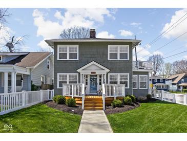 Charming two-story home featuring a welcoming front porch and well-maintained landscaping at 4850 Guilford Ave, Indianapolis, IN 46205