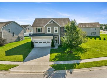 Charming two-story home with a manicured lawn, two car garage and a well-maintained landscape at 6615 School Branch Dr, Brownsburg, IN 46112