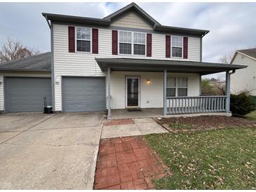 Charming two-story home featuring red shutters, a covered porch, and a convenient attached garage at 7130 English Birch Ln, Indianapolis, IN 46268