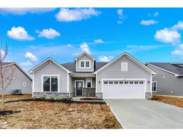 Charming single Gathering home with stone accents, a two-car garage and impeccable curb appeal at 7170 Rose Hill Ave, Brownsburg, IN 46112