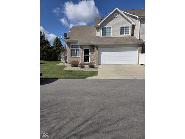 Two-story home with an attached garage and well-kept lawn under a sunny, blue sky at 8160 Shores Edge Way, Indianapolis, IN 46237