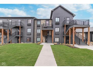 Modern apartment complex showcases beautiful landscaping, private balconies, and exterior stairways at 102 Clarendon Dr # 514, Noblesville, IN 46062