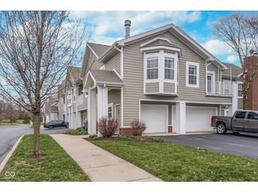 Charming townhouse featuring a two-car garage, neutral siding, and well-maintained landscaping at 1160 Falcon Rdg, Carmel, IN 46280