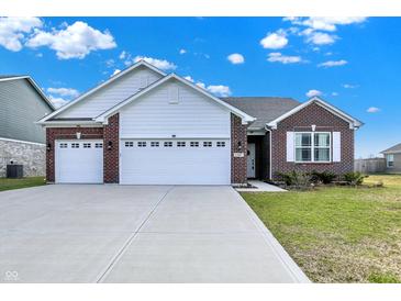 Charming single-story home with brick accents, a spacious driveway, and a well-manicured lawn at 1347 Shaw Ln, Shelbyville, IN 46176
