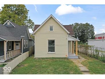 Charming exterior of a cream-colored two-story home with a well-maintained lawn and inviting curb appeal at 1426 S Talbott St, Indianapolis, IN 46225