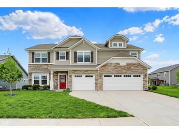 Beautiful two-story home with a stone facade and a three-car garage at 15752 Matthews Ln, Noblesville, IN 46060