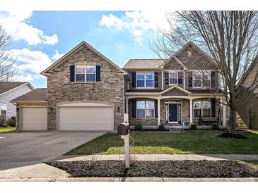 Charming two-story home with stone facade, well-manicured lawn, and a convenient three-car garage at 15898 Bounds Dr, Noblesville, IN 46062