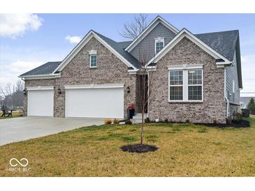 Beautifully designed two-story brick home with a three car garage and a well maintained lawn at 19036 Karyn Ln, Noblesville, IN 46062