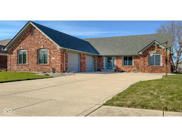 View of the all-brick single-story home with attached garage and basketball hoop on the driveway at 2054 Partridge Dr, Franklin, IN 46131