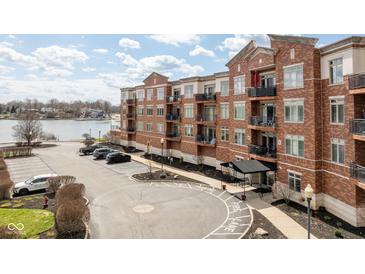 Beautiful condo building with red brick, balconies, and lake view offers ample parking and convenient amenities at 20971 Shoreline Ct # Apt 212, Noblesville, IN 46062