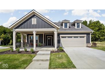 Charming single-Gathering home featuring a two-car garage, covered front porch, and well-maintained landscaping at 2786 Kipling Dr, Carmel, IN 46033
