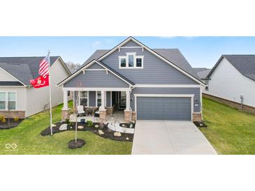 Beautiful single-Gathering home featuring a charming front porch, well-manicured lawn, and attached two-car garage at 3121 Arkle Rd, Westfield, IN 46074