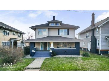 Charming two-story home featuring a covered front porch and well-maintained landscaping at 3345 Ruckle St, Indianapolis, IN 46205