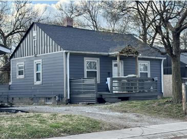A charming one-story home with gray siding, dark roof, and inviting front porch, perfect for relaxing outdoors at 3422 Hillside Ave, Indianapolis, IN 46218