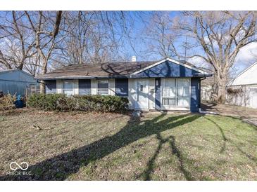 Charming single-story home featuring a blue exterior, well-kept yard, and mature trees at 4008 N Mitthoefer Rd, Indianapolis, IN 46235