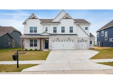 Two-story home with white siding, a two-car garage, brick accents, and a well-manicured lawn at 4241 Risen Star Way, Bargersville, IN 46106