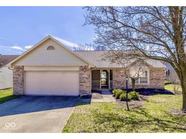 Charming single-story home with a well-manicured lawn and attached two-car garage at 4655 Welton St, Greenwood, IN 46143
