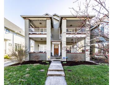 Charming two-story home features a classic design with inviting balconies and a well-manicured front lawn at 1727 N New Jersey St # A, Indianapolis, IN 46202