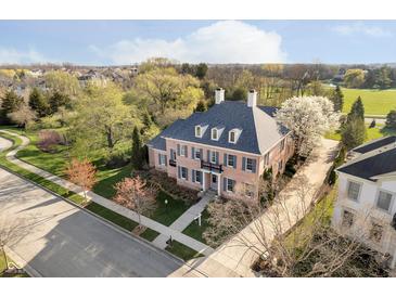 Stunning aerial view of a brick home with mature trees and manicured lawn in a desirable neighborhood at 1997 Finchley Rd, Carmel, IN 46032