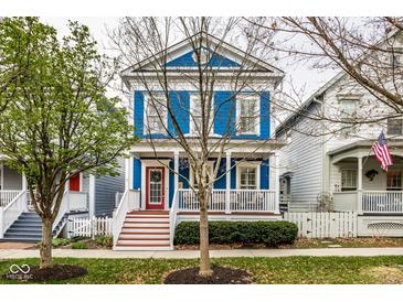 Charming blue two-story home with a welcoming front porch and neatly landscaped yard in a neighborhood setting at 2067 Rhettsbury St, Carmel, IN 46032