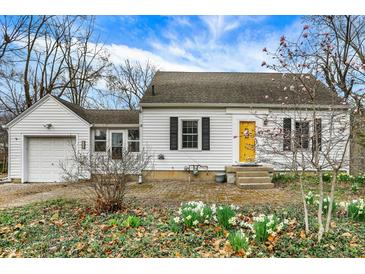 View of the front exterior of the home, showcasing a yellow front door at 214 W Elbert St, Indianapolis, IN 46217