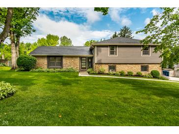 Charming home with manicured lawn, stone accents, and gray siding, offering great curb appeal at 224 Brierley Way, Carmel, IN 46032