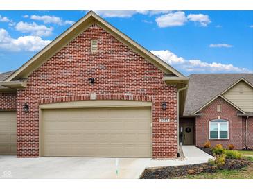 Charming single-Gathering home features a red brick exterior, attached garage, and manicured landscaping at 2753 Stones Bay Dr, Greenwood, IN 46143