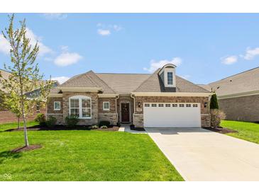 Charming brick home with a well-manicured lawn and attached two car garage at 3941 Stratfield Way, Westfield, IN 46074