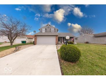 Charming two-story home featuring a two-car garage and well-manicured front lawn with mature landscaping at 628 Southridge Ct, Westfield, IN 46074