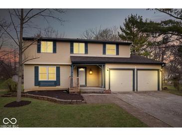 Charming two-story home featuring a two-car garage, neutral siding and complemented by a well-manicured lawn at 6602 Boston Ridge Ct, Indianapolis, IN 46237