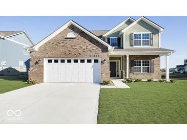 Charming two-story home with brick accents, a two-car garage, and a well-manicured lawn at 943 Rushmore Dr, Pittsboro, IN 46167
