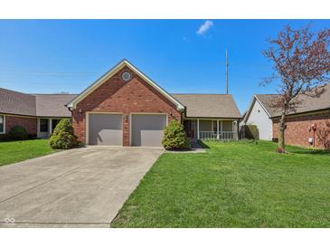 Charming single-story brick home with a two-car garage and well-manicured lawn at 138 President W Trl, Indianapolis, IN 46229