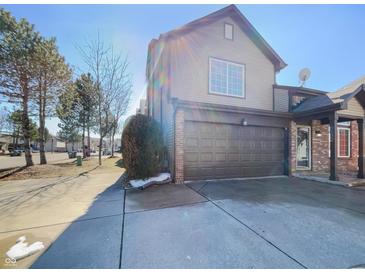 Inviting home with a two-car garage and appealing curb appeal and well maintained landscaping at 2632 Frasier Fir Dr, Greenwood, IN 46143