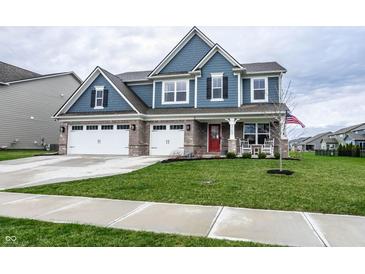 Charming two-story home with a three-car garage and a well-manicured front yard at 3164 Kent Dr, Brownsburg, IN 46112