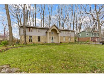 Charming home featuring a stone and siding facade with a well-manicured lawn at 4140 Melbourne Rd, Indianapolis, IN 46228