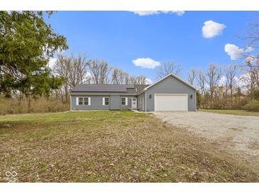 Charming single-story home featuring vinyl siding, solar panels and an attached two car garage at 4221 Millersville Rd, Indianapolis, IN 46205