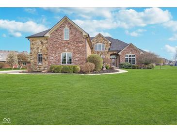 Inviting two-story brick home with a manicured lawn and beautiful landscaping at 519 Southwind, Brownsburg, IN 46112