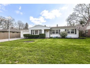 Charming single-story home with well-manicured lawn, inviting curb appeal, and attached garage at 5849 Brouse Ave, Indianapolis, IN 46220