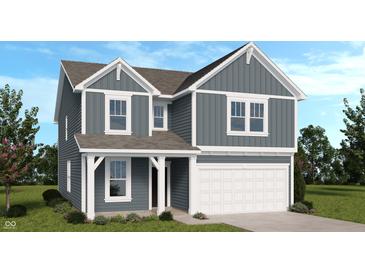Charming two-story home showcasing blue siding, white trim, a covered porch, and an attached two-car garage at 8710 Hollander Dr, Camby, IN 46113