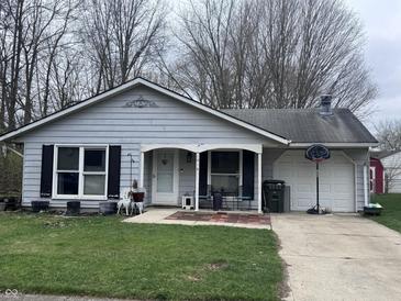 Charming single-story home featuring a well-maintained lawn and attached garage at 1016 Alden Dr, Fortville, IN 46040