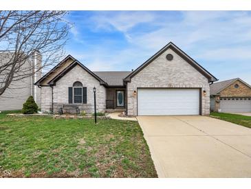 Charming single-story home with a brick facade, attached garage, and well-maintained lawn and landscaping at 1086 Meadowview Ct, Franklin, IN 46131