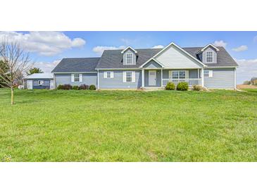Charming two-story home with a covered front porch and a well-maintained lawn on a sunny day at 1502 W 525 N, Lebanon, IN 46052