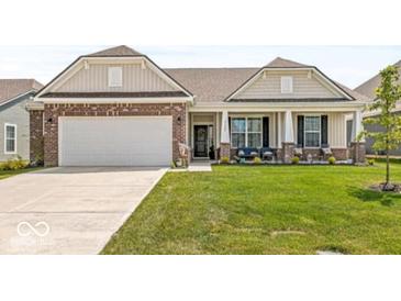 Charming single-story home with brick accents, a two-car garage, and a well-manicured front lawn at 17865 Haralson Row, Westfield, IN 46074