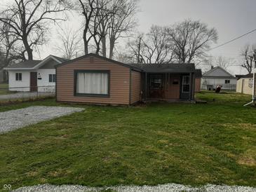 Charming single-story home with lawn and gravel driveway at 2233 W 28Th St, Anderson, IN 46016