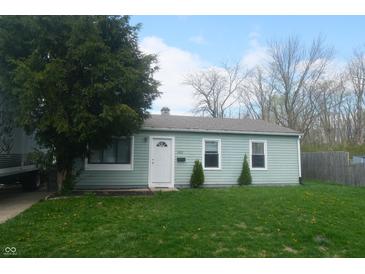 Charming single-story home with a well-maintained front yard and a classic white door at 4502 W 36Th St, Indianapolis, IN 46222